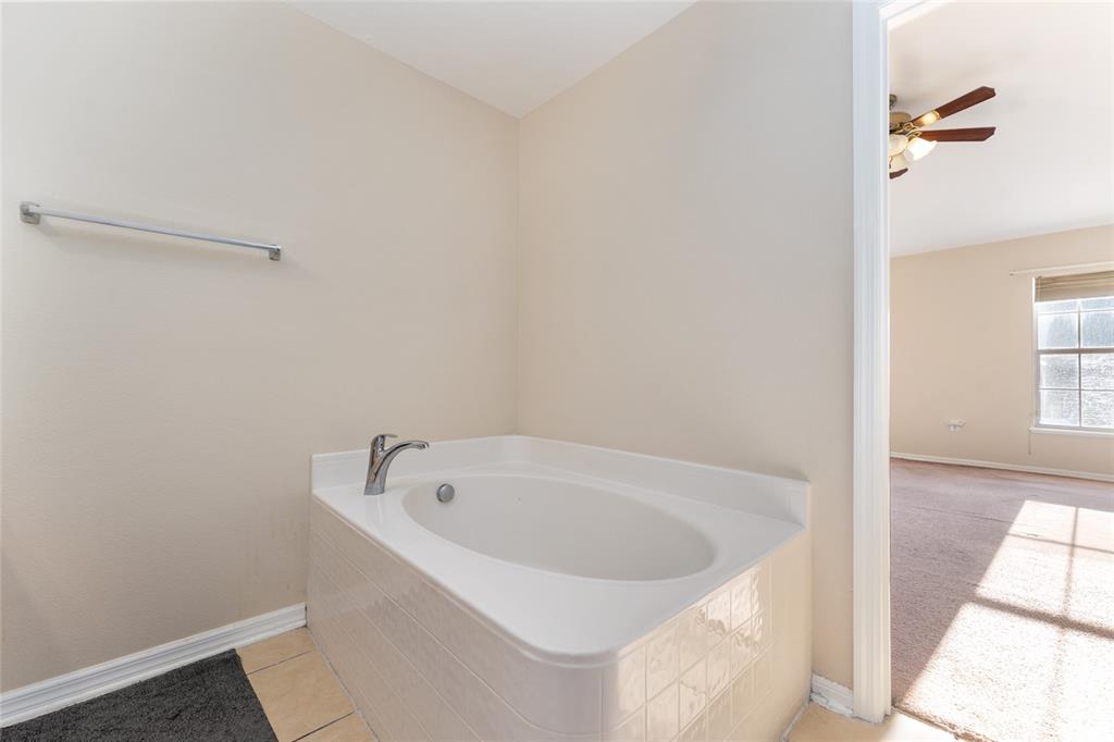 2661 Northeast 42nd Road Ocala, FL 34470 - Photo 51 of 74 a white bath tub sitting in a bathroom