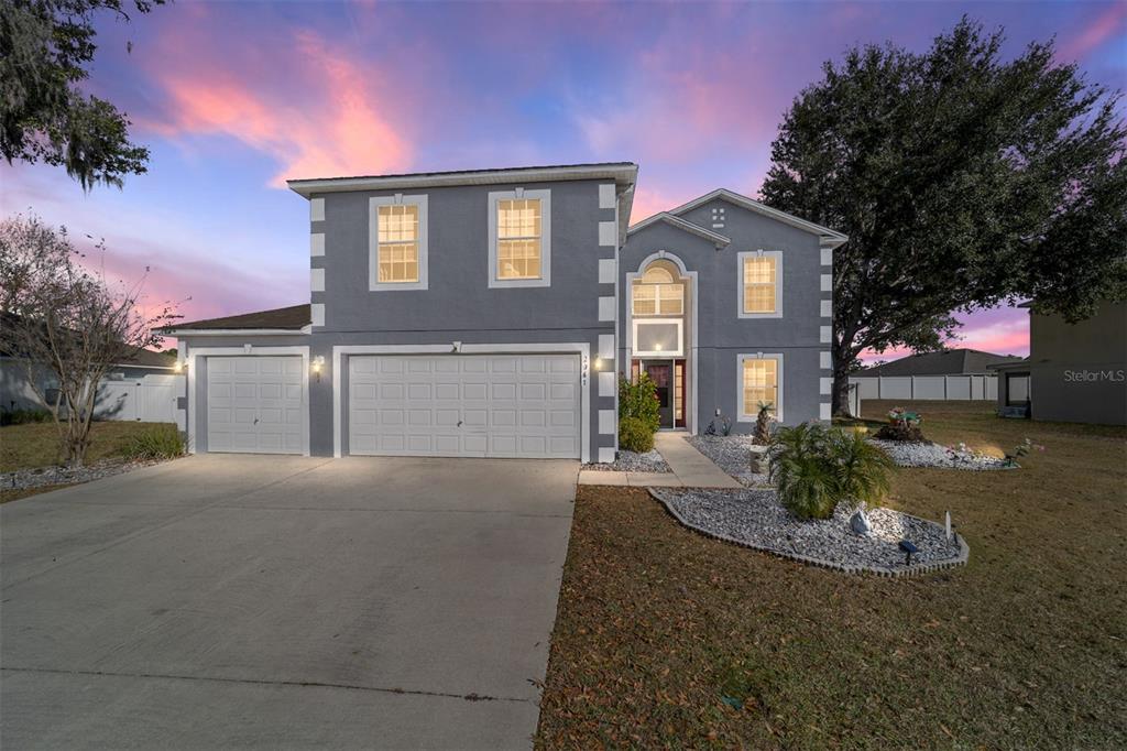 2661 Northeast 42nd Road Ocala, FL 34470 - Photo 74 of 74 a front view of a house with a yard and garage