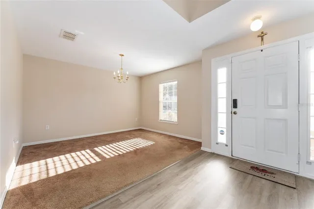 a view of an empty room and wooden floor