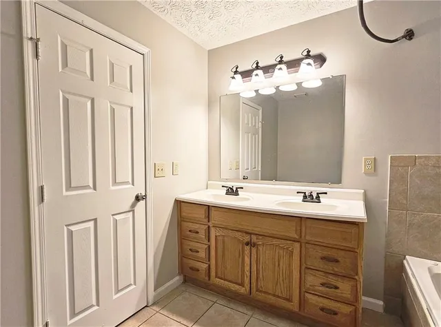 a bathroom with a double vanity sink mirror and