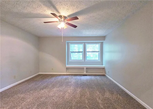 a view of room window and ceiling fan