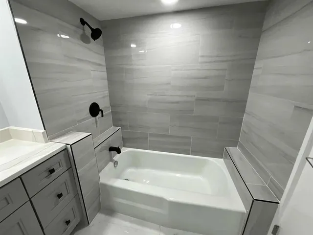 a bathroom with a bathtub and shower