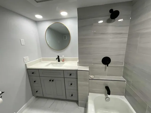 a bathroom with a sink a toilet and shower