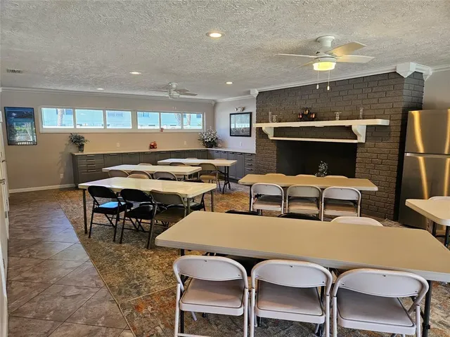 a kitchen with stainless steel appliances granite countertop a refrigerator a stove a sink and a microwave