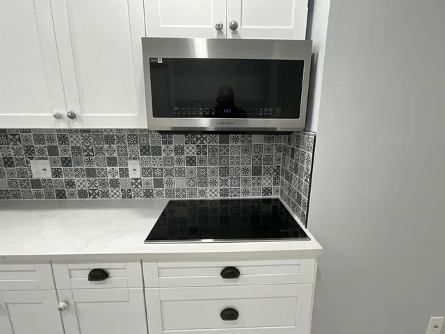 a close view of a stove a microwave and cabinets