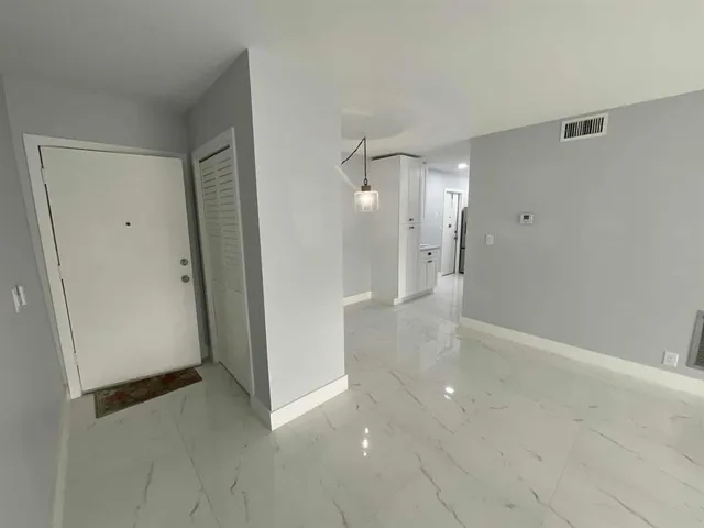 a view of a hallway with wooden shelves