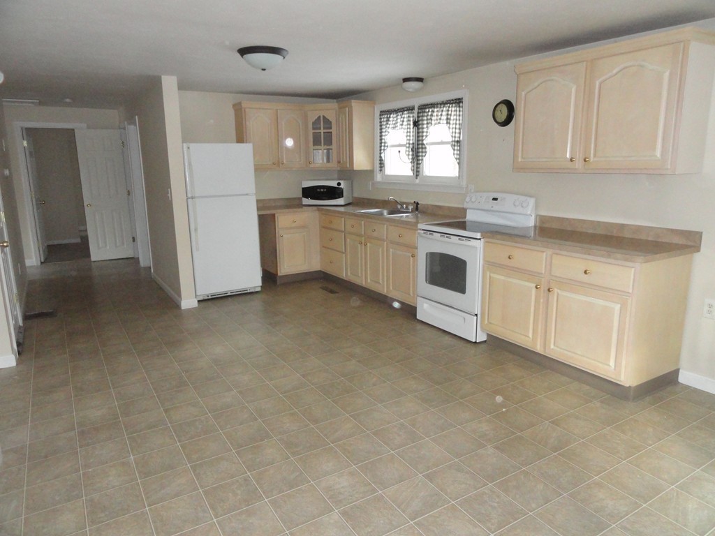 38 Davis Street Rutland, MA 01543 - Photo 3 of 20 a kitchen with white cabinets and white appliances