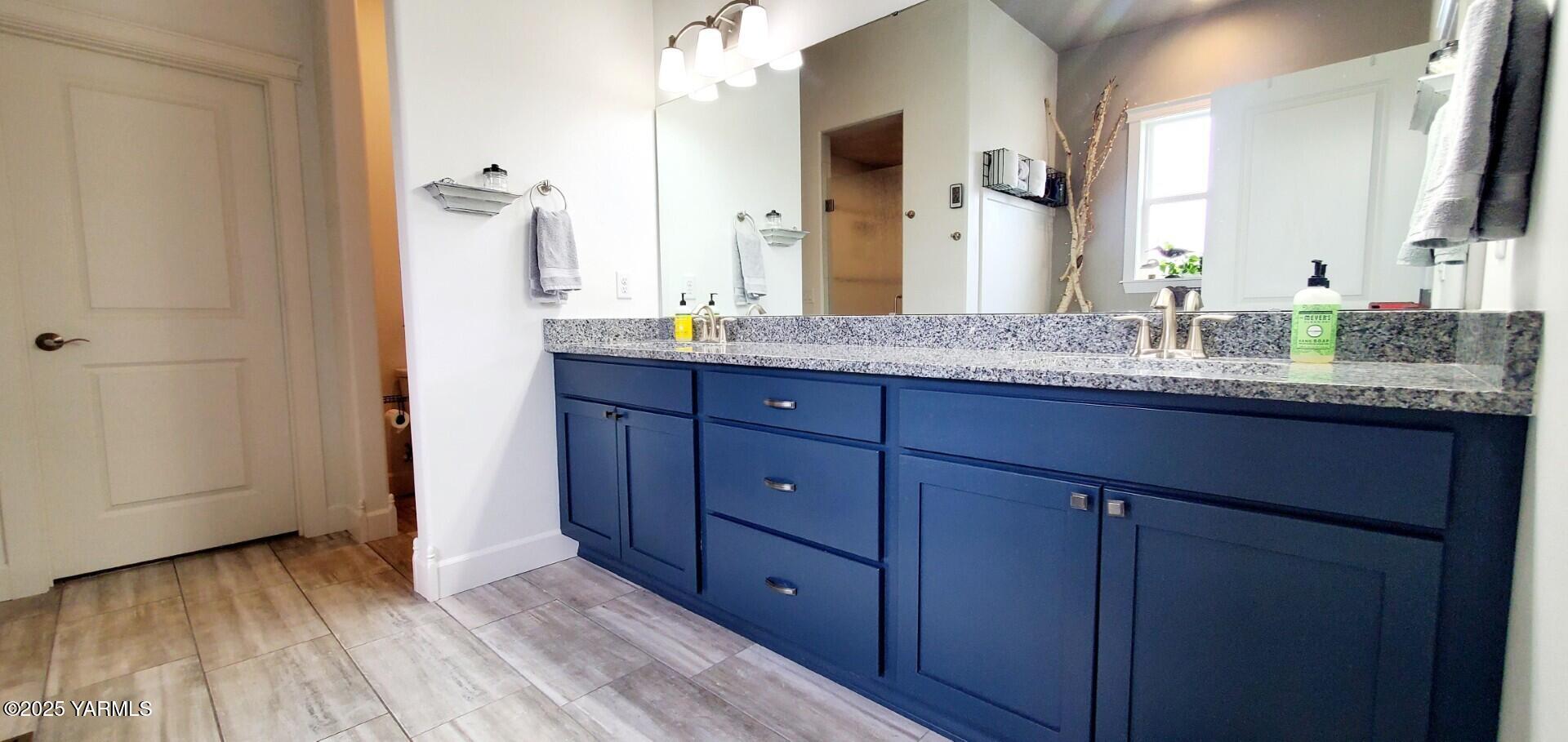 7106 Vista Ridge Avenue Yakima, WA 98903 - Photo 16 of 43 a bathroom with a granite countertop sink and a mirror