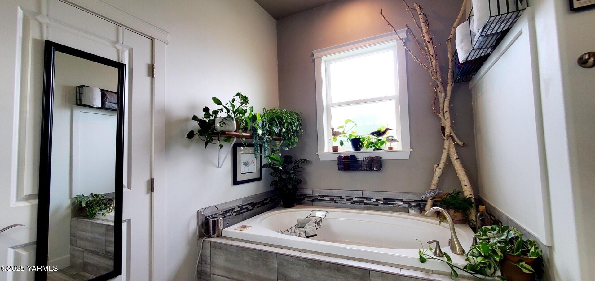 7106 Vista Ridge Avenue Yakima, WA 98903 - Photo 17 of 43 a bath tub sitting in a bathroom next to a window