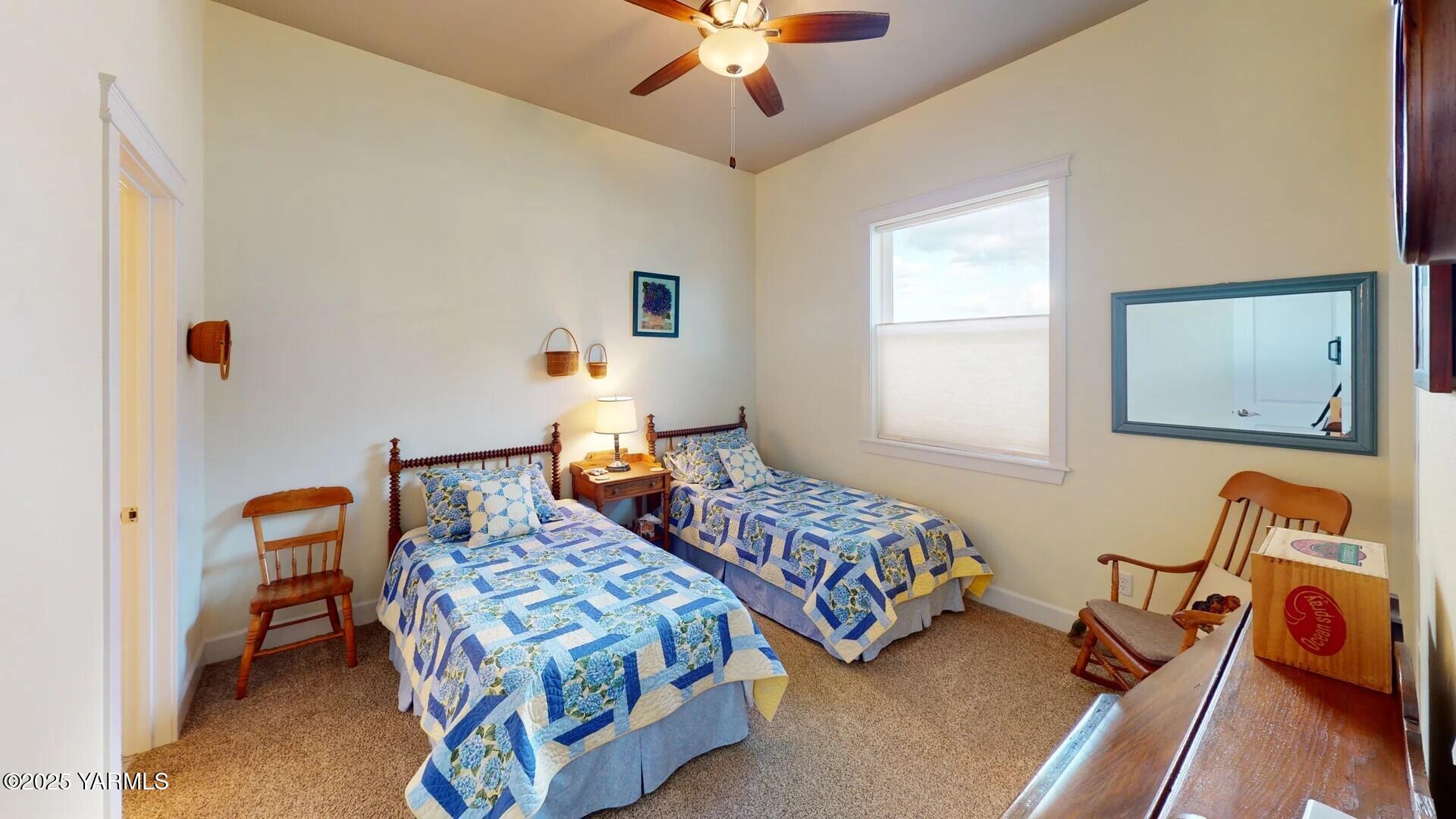 7106 Vista Ridge Avenue Yakima, WA 98903 - Photo 21 of 43 a bedroom with two beds and a chandelier