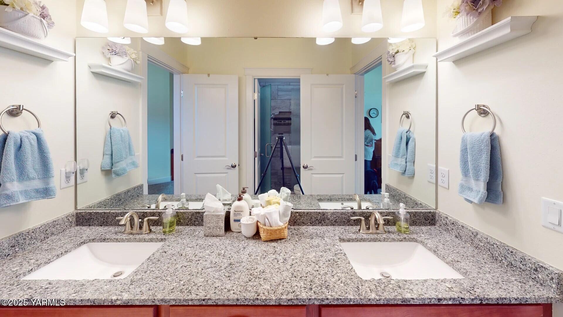 7106 Vista Ridge Avenue Yakima, WA 98903 - Photo 27 of 43 a bathroom with a granite countertop sink and a mirror