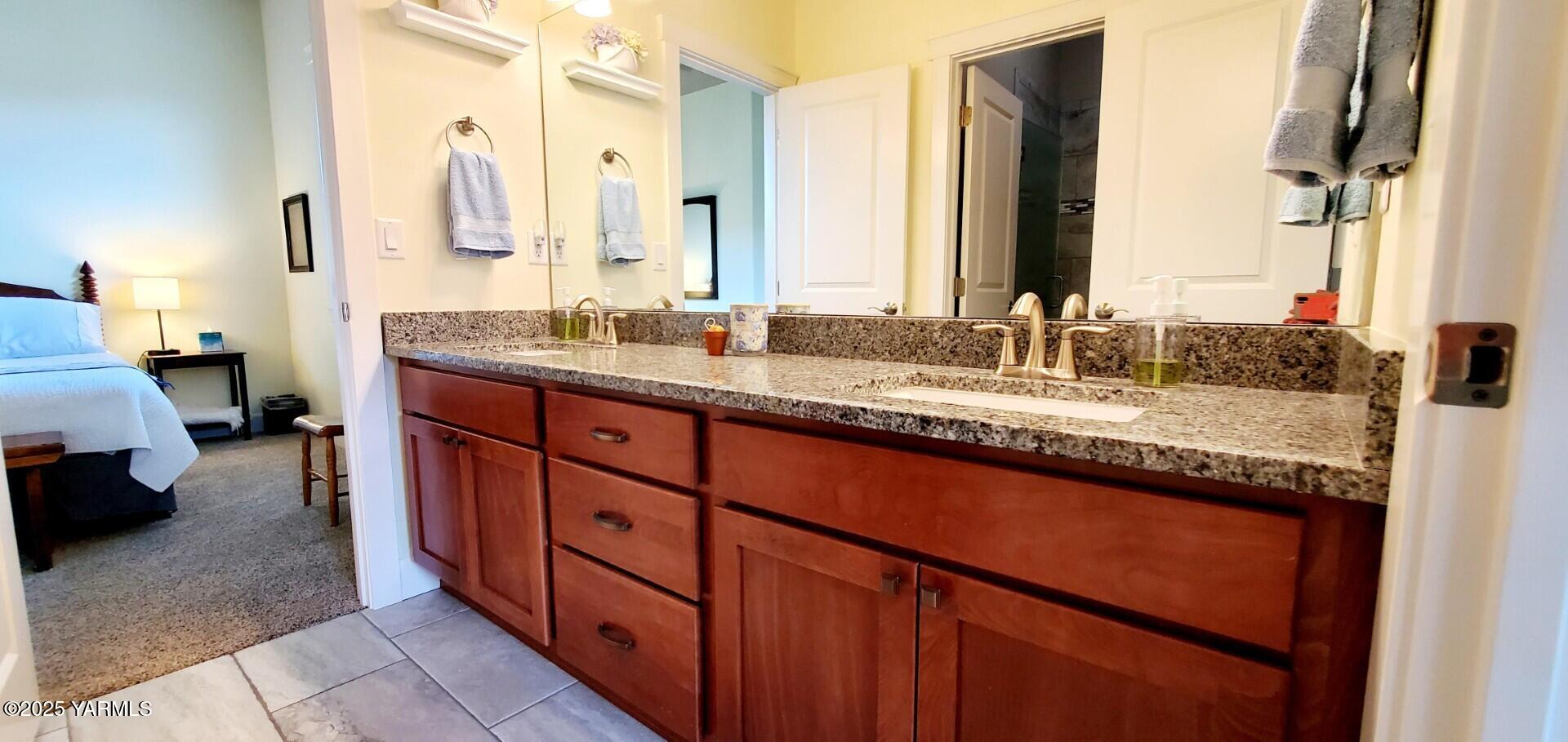 7106 Vista Ridge Avenue Yakima, WA 98903 - Photo 28 of 43 a bathroom with a granite countertop sink and a mirror