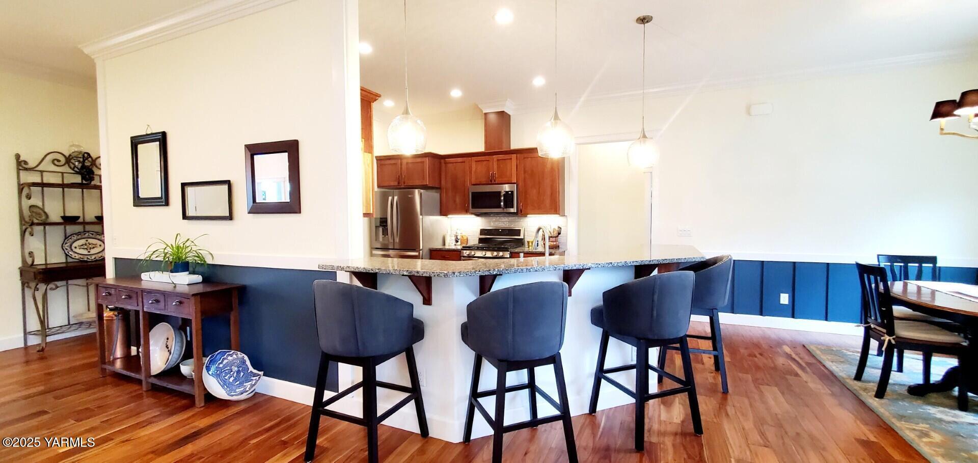 7106 Vista Ridge Avenue Yakima, WA 98903 - Photo 8 of 43 a view of a dining room with furniture and wooden floor