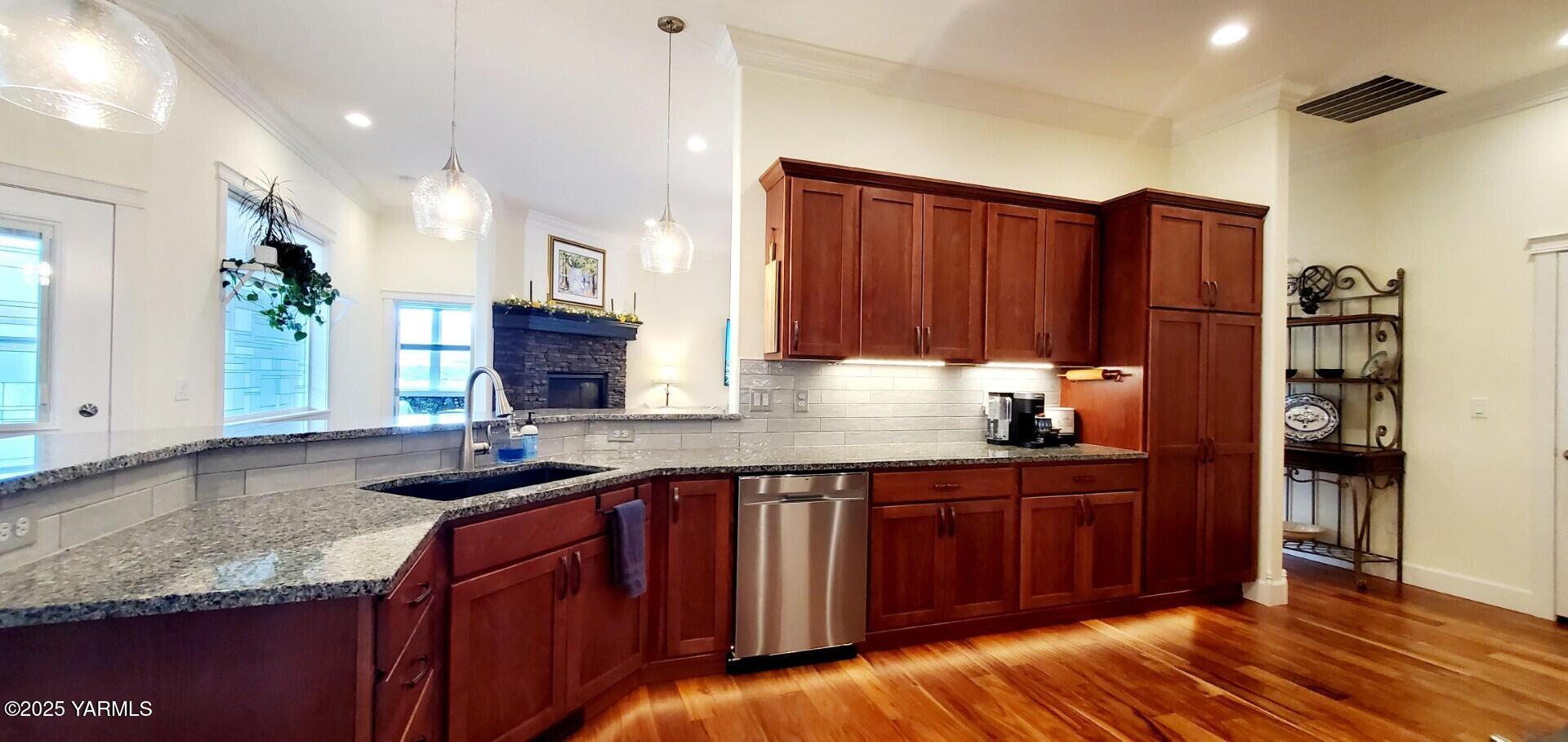 7106 Vista Ridge Avenue Yakima, WA 98903 - Photo 10 of 43 a kitchen with stainless steel appliances granite countertop wooden cabinets a sink and dishwasher