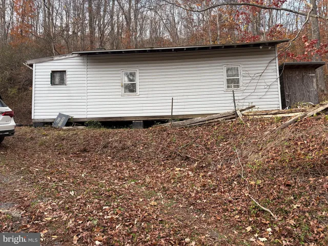 a black and white house with a yard