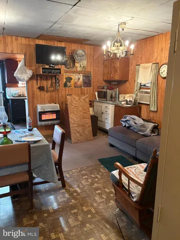 a living room with lots of furniture and chandelier