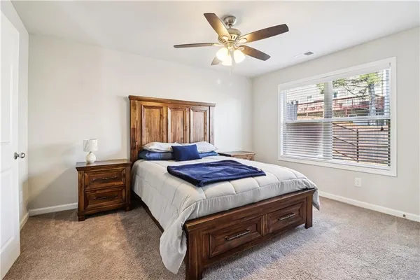 a bedroom with a bed and a large window