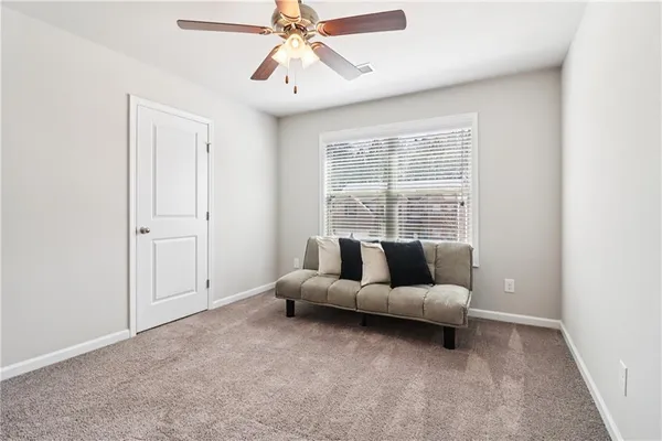a living room with furniture and windows
