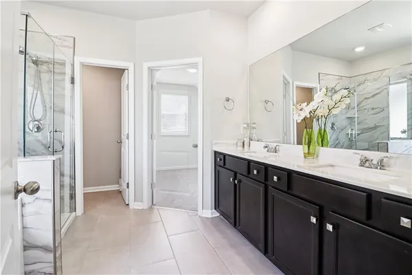 a spacious bathroom with a double vanity sink mirror and double