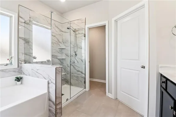 a bathroom with a tub sink and shower