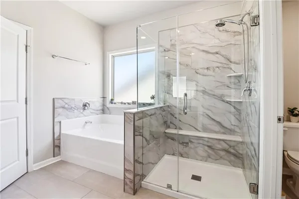 a bathroom with a bathtub and a shower