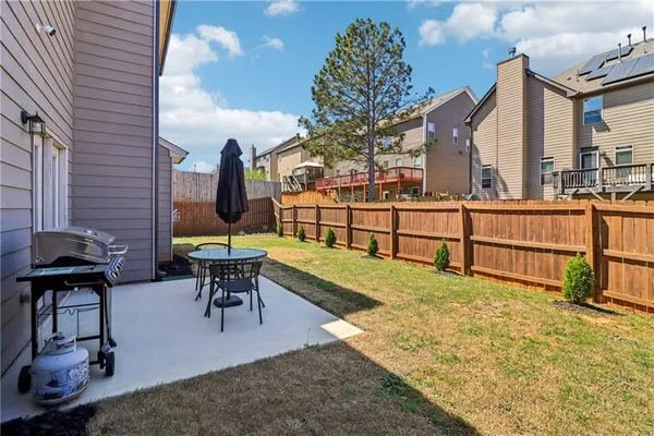 a view of a house with backyard and sitting area