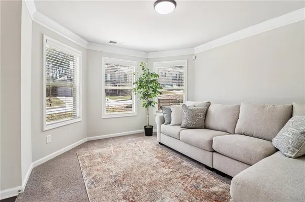 a living room with furniture and a potted plant