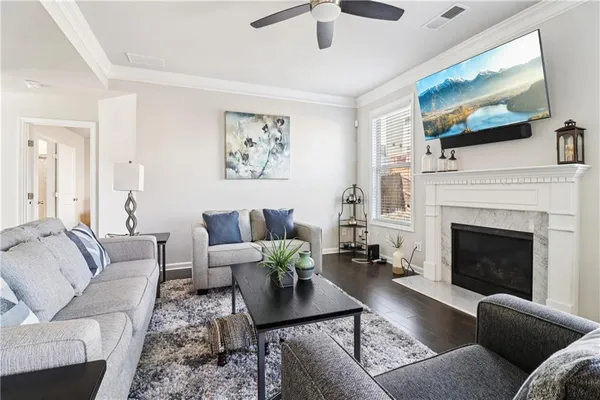 a living room with furniture a flat screen tv and a fireplace