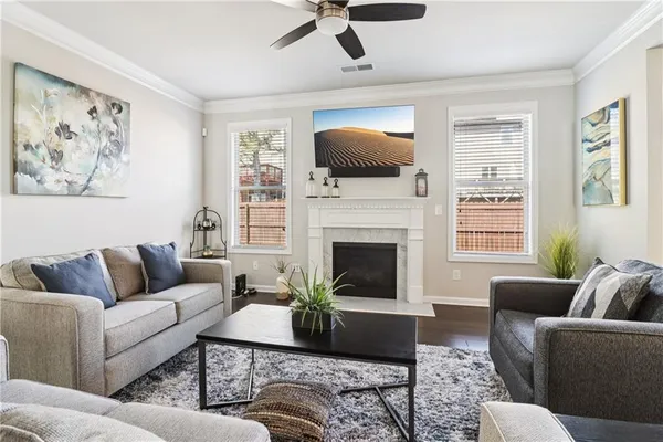 a living room with furniture a flat screen tv and a fireplace