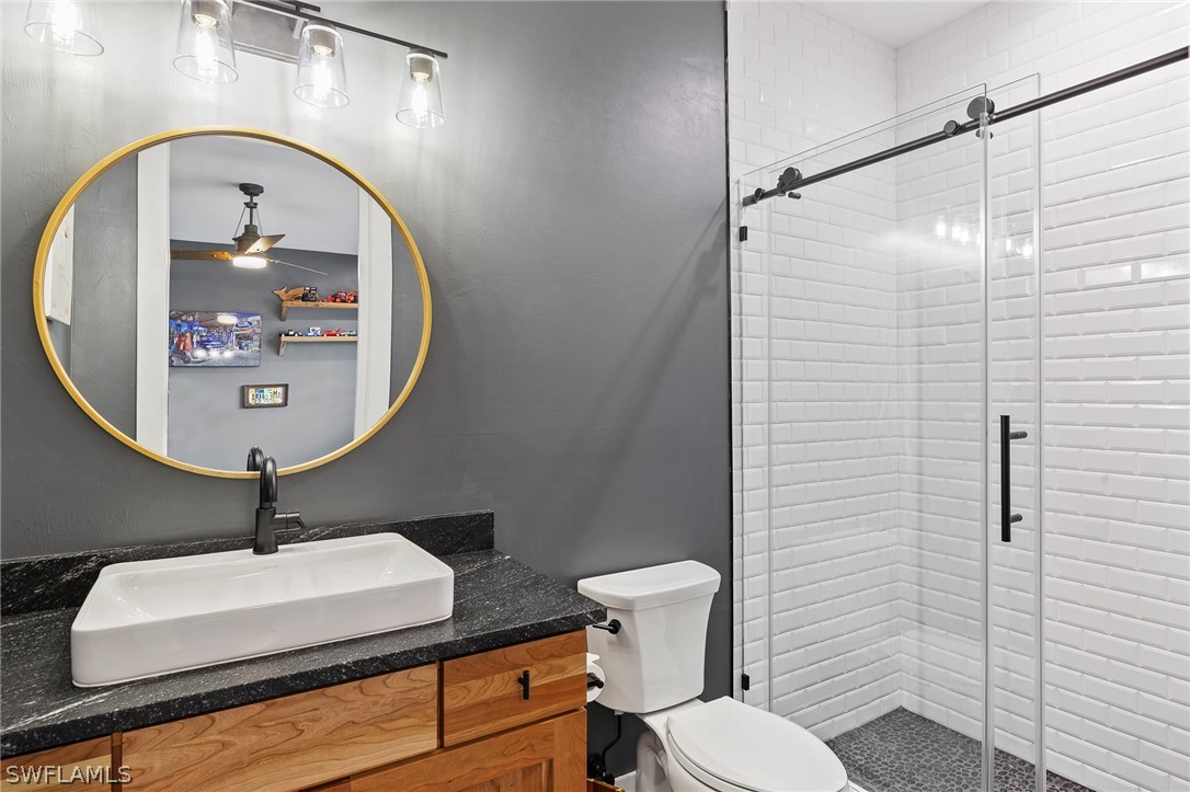 5400 Dana Road Fort Myers, FL 33905 - Photo 22 of 35 a bathroom with a toilet sink and mirror
