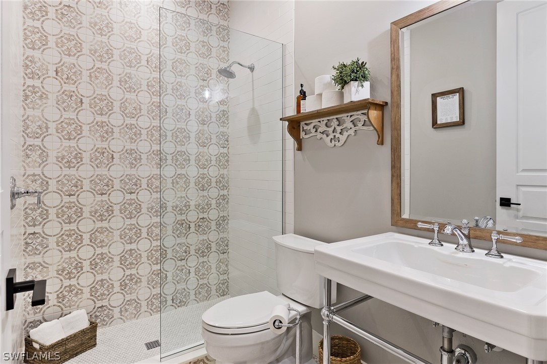 5400 Dana Road Fort Myers, FL 33905 - Photo 25 of 35 a bathroom with a sink a toilet and a mirror