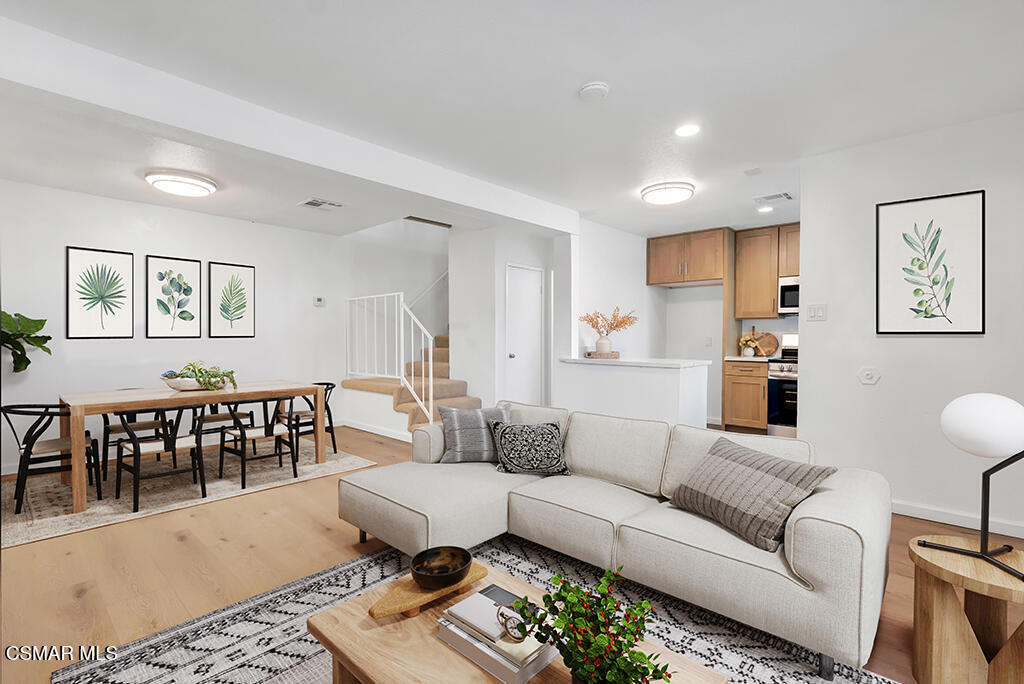 a living room with furniture or couch and a dining table
