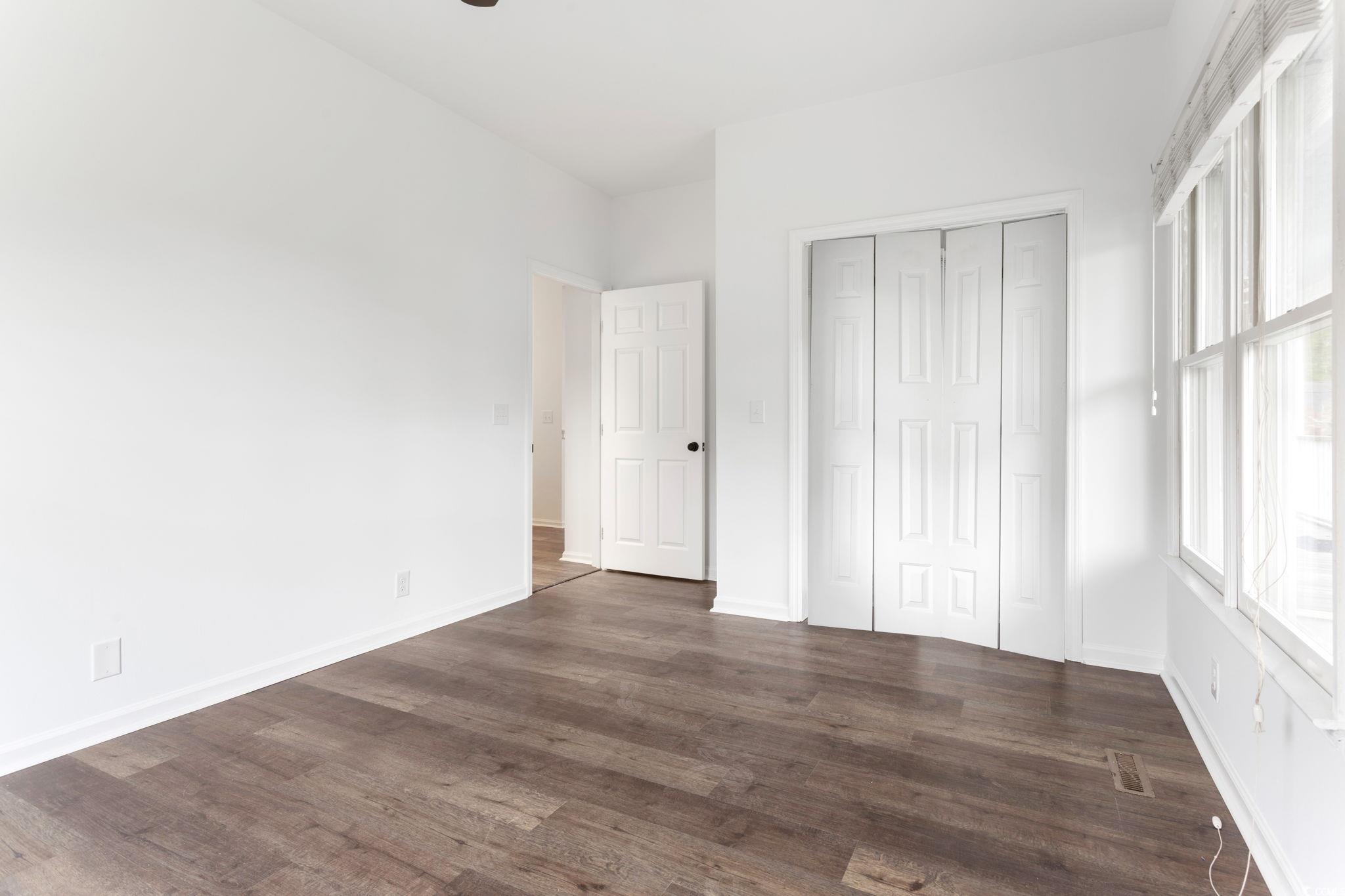2321 Brick Drive Longs, SC 29568 - Photo 29 of 40 Unfurnished bedroom featuring dark wood-style floors and a closet