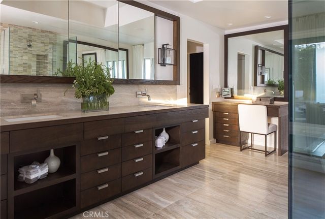 a spacious bathroom with a sink double vanity and a mirror