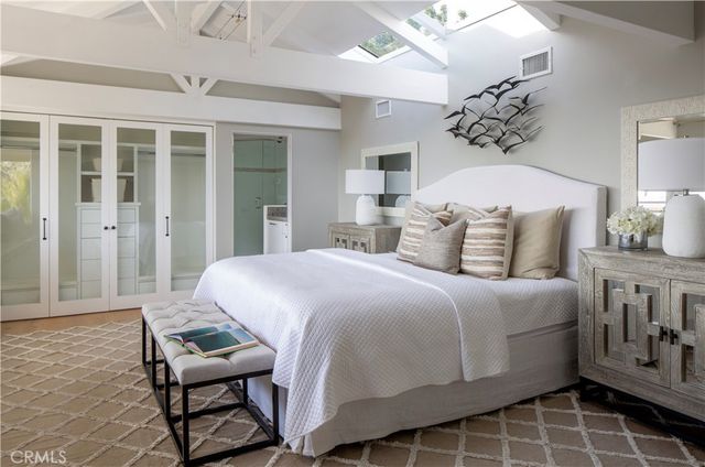 a bed room with a bed and a chair