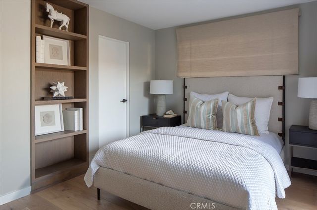 a bedroom with a bed and a refrigerator