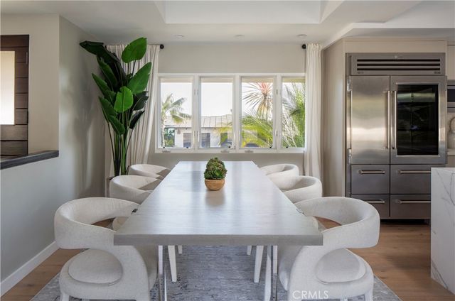 a view of a dining room with furniture and a potted plant