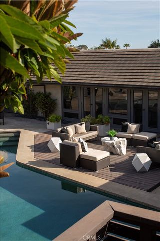 a view of a patio with table and chairs and potted plants