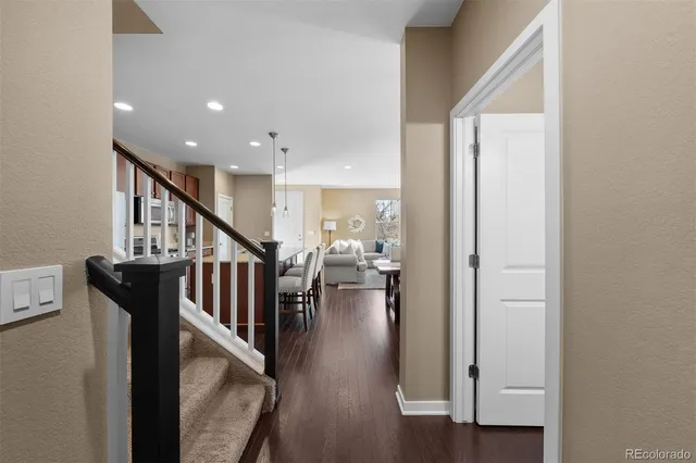 a view of entryway and hall with wooden floor