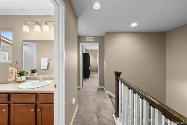 a bedroom with a bed and a ceiling fan