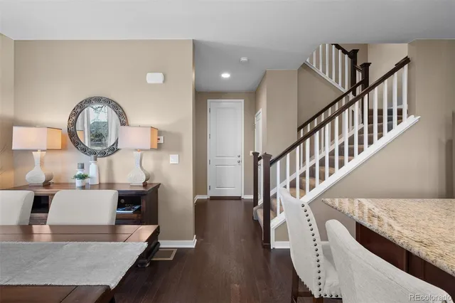 a view of a livingroom with furniture a table and wooden floor