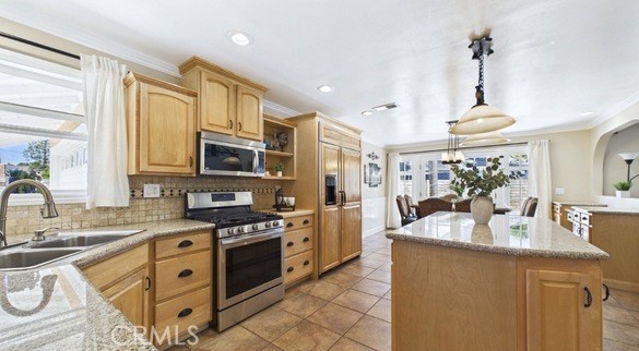 21104 Rosedell Drive Saugus, CA 91350 - Photo 10 of 33 Beautiful kitchen with center island, granite countertops, travertine backsplash and matching refrigerator panels