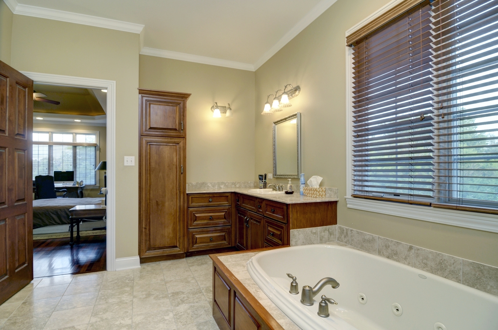 510 Rookery Lane Joliet, IL 60431 - Photo 14 of 40 a bathroom with a tub a sink and a large mirror