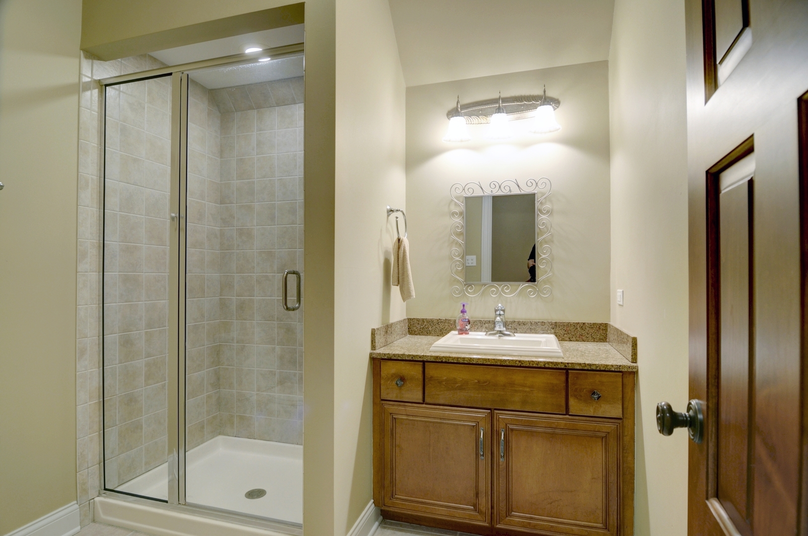 510 Rookery Lane Joliet, IL 60431 - Photo 27 of 40 a bathroom with a shower sink vanity and mirror