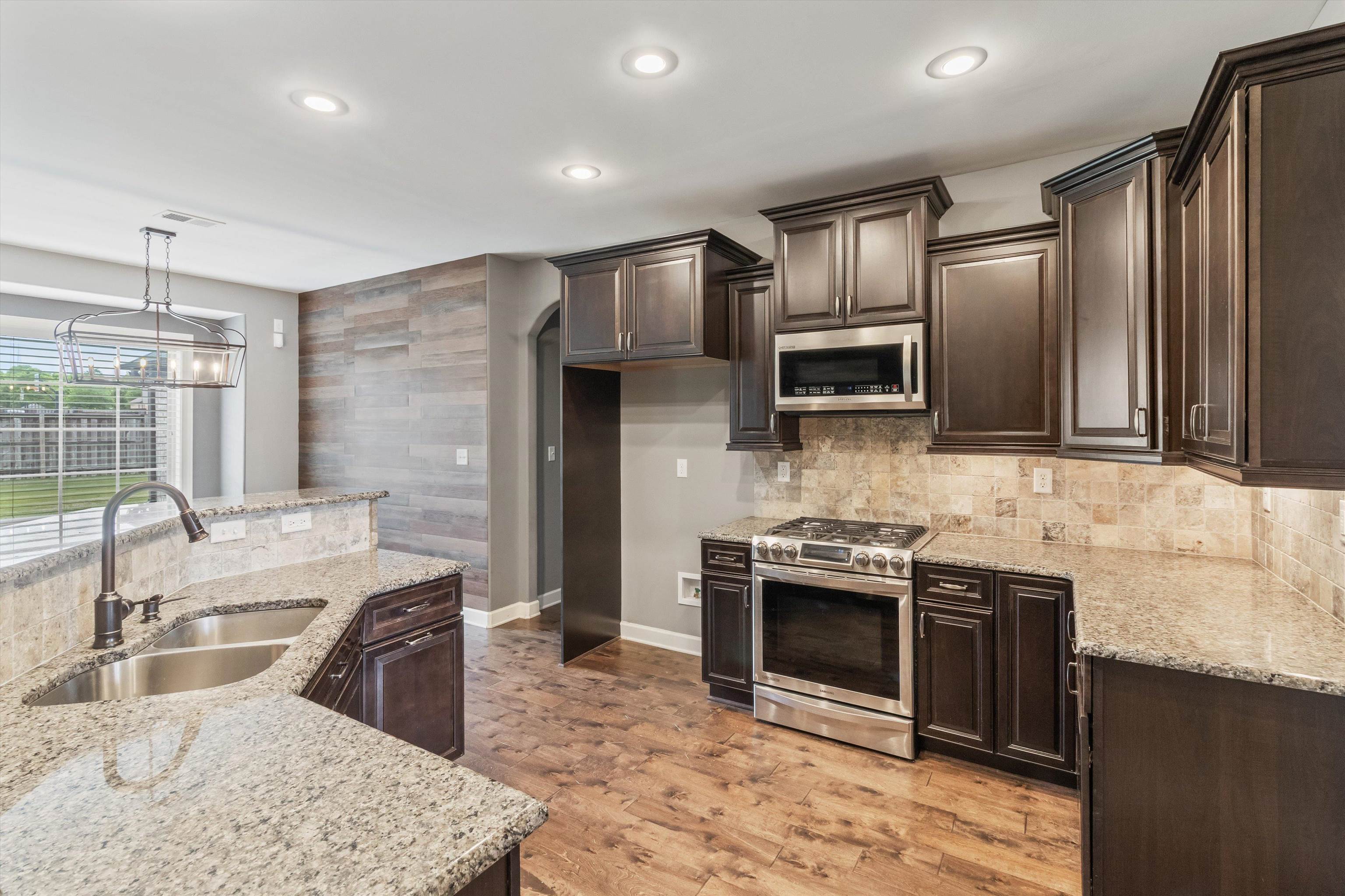 3449 Banyan Lane Bartlett, TN 38133 - Photo 13 of 35 a kitchen with stainless steel appliances granite countertop a sink stove and refrigerator