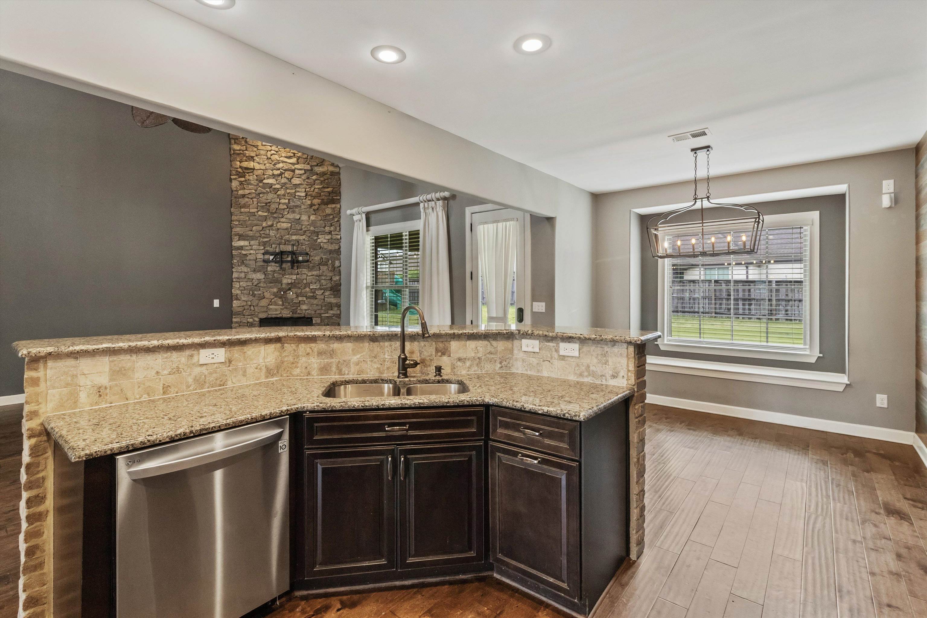 3449 Banyan Lane Bartlett, TN 38133 - Photo 14 of 35 a kitchen with stainless steel appliances granite countertop a sink stove and cabinets