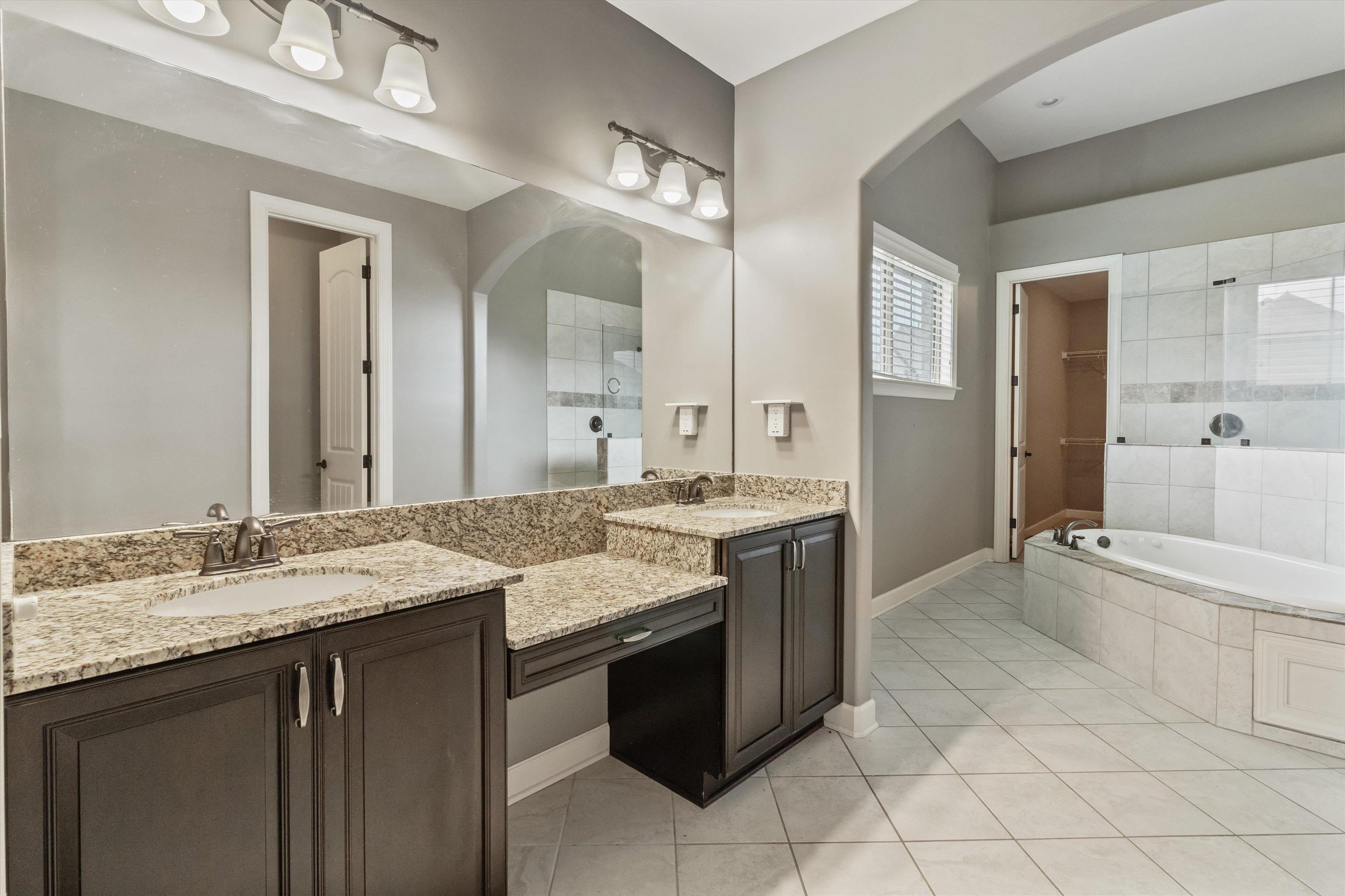 3449 Banyan Lane Bartlett, TN 38133 - Photo 23 of 35 a bathroom with a granite countertop sink and a mirror
