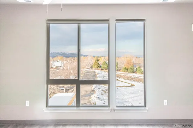 a bathroom with a glass door and a window