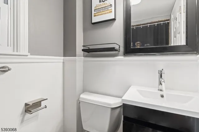 a bathroom with a sink a toilet and mirror