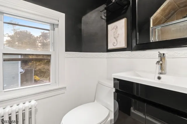 a bathroom with a toilet a sink and mirror